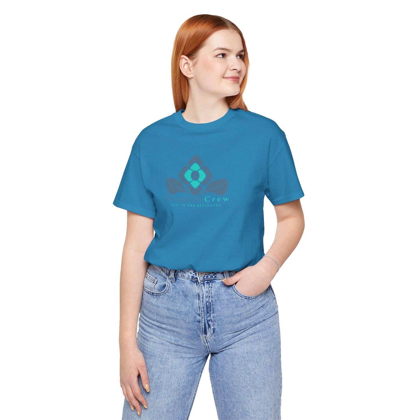 Forgiven Crew Christian Clothing Model showing the front of the teal christian t-shirt, Christian shirt has a blue 2 tones flower with forgiven crew and est. in the beginning printed below the flower