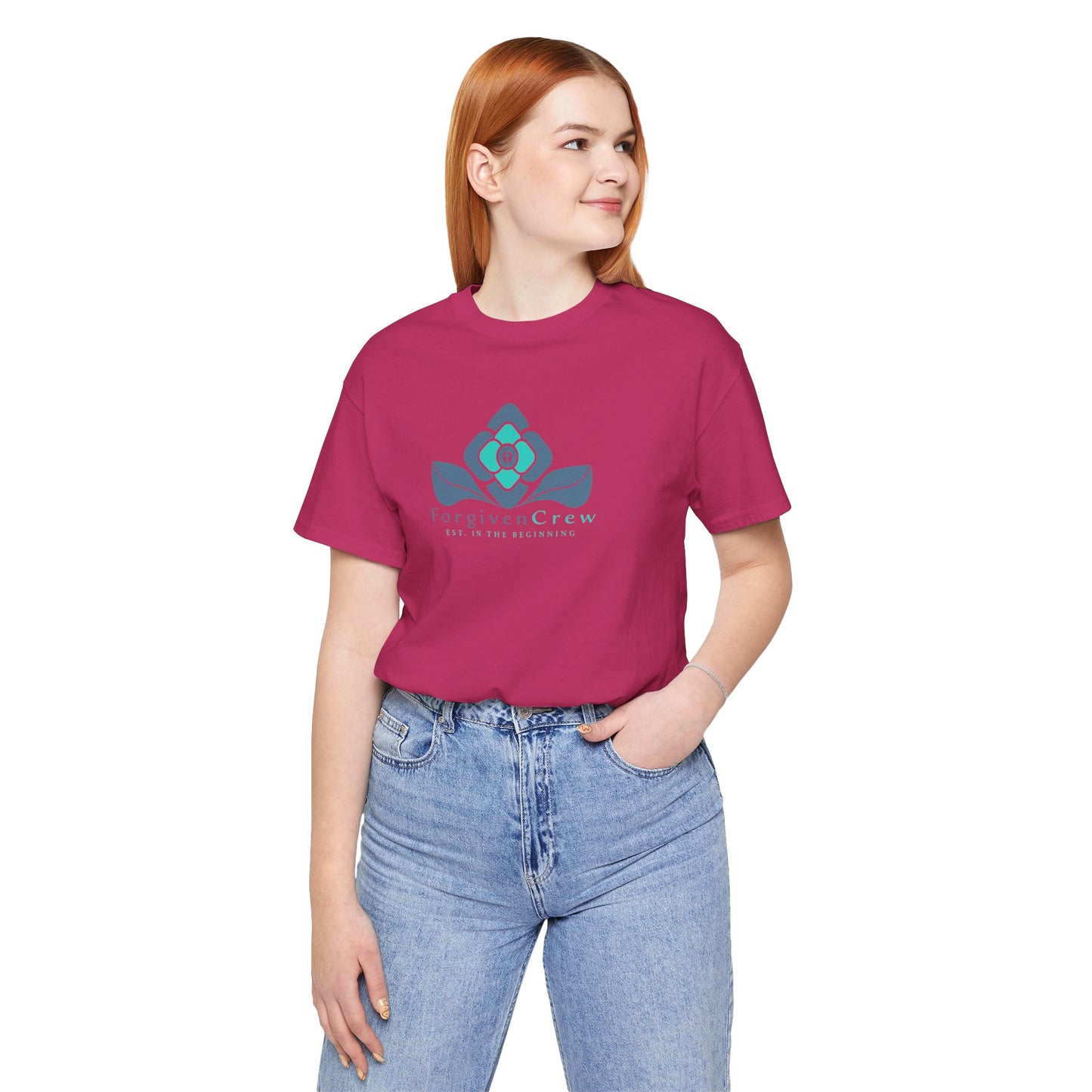Forgiven Crew Christian Clothing Model showing the front of the pink christian t-shirt, Christian shirt has a blue 2 tones flower with forgiven crew and est. in the beginning printed below the flower